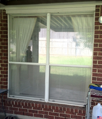 Before shot of a twin aluminum builders grade window with single paned glass.  Eighty percent of the windows out there are this style and type.