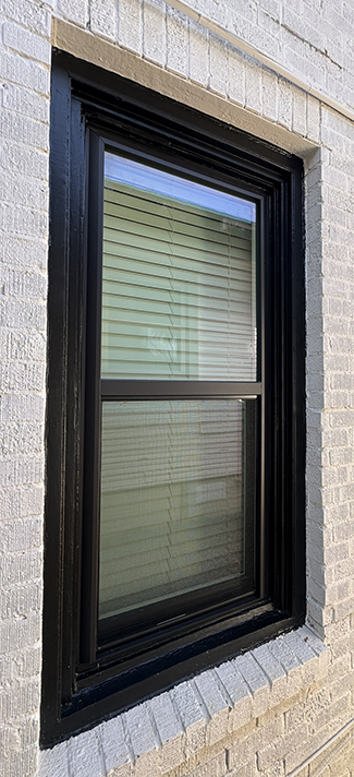 Vinyl replacement window installation with new wood trim
